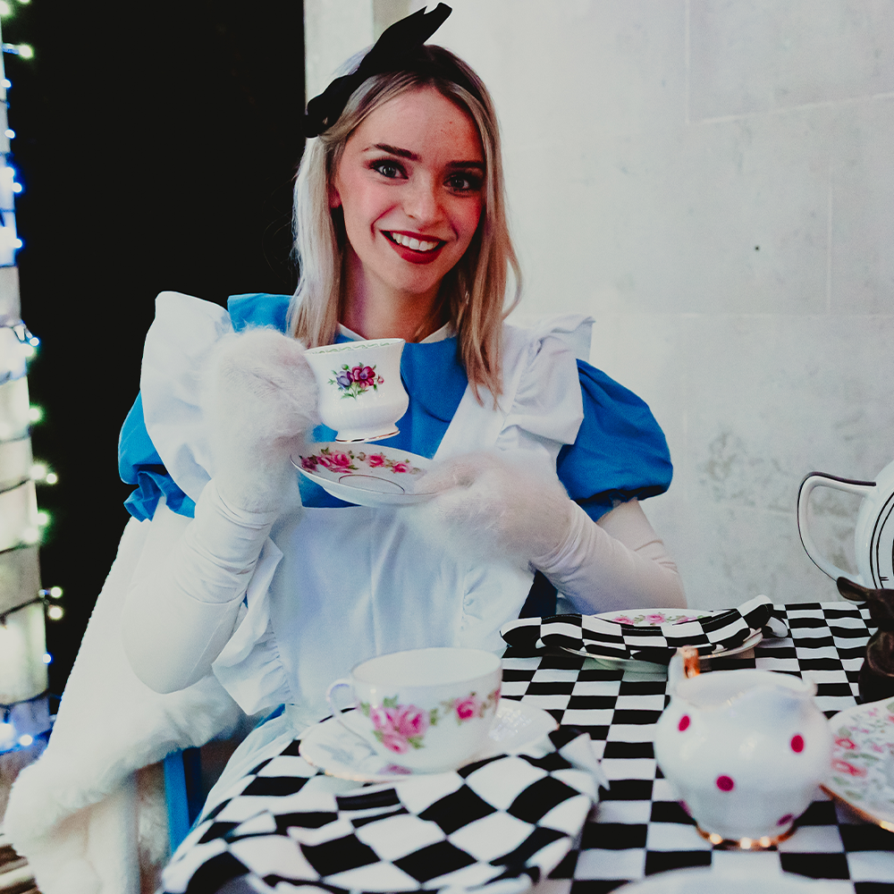 Alice holding a tea cup at Wonderglow 
